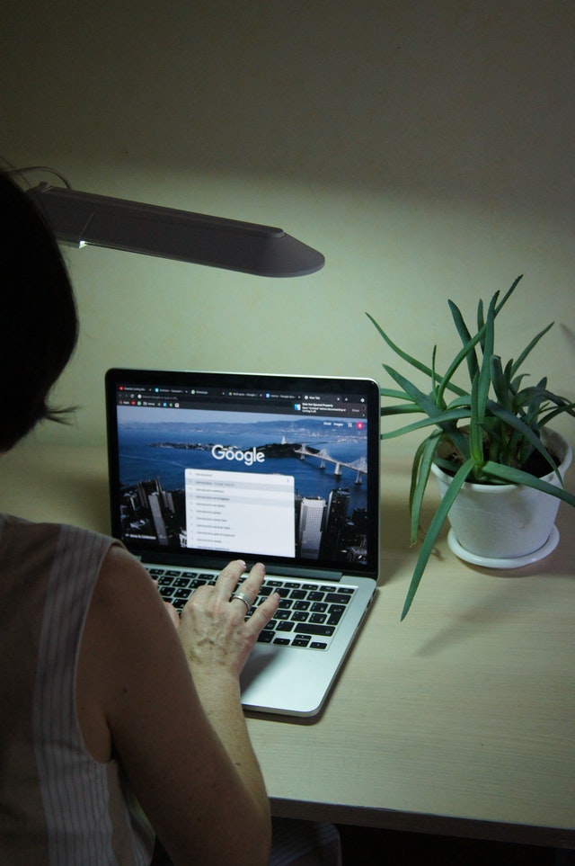 woman using google on laptop