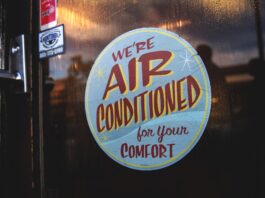 a button on a door that says they are air conditioned for your comfort